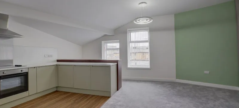 An open-plan apartment kitchen and living room let by Real Rentals